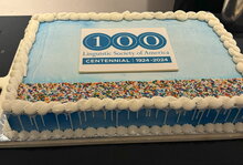 Cake with centennial LSA logo in blue icing